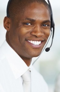 Portrait of an African American business man with his blur team in a call centre